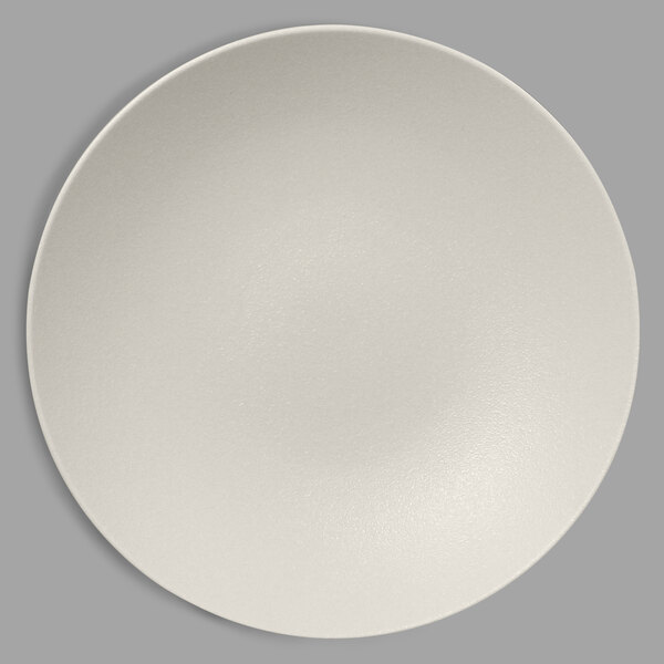 A RAK Porcelain sand white deep coupe plate with a round rim on a white surface.