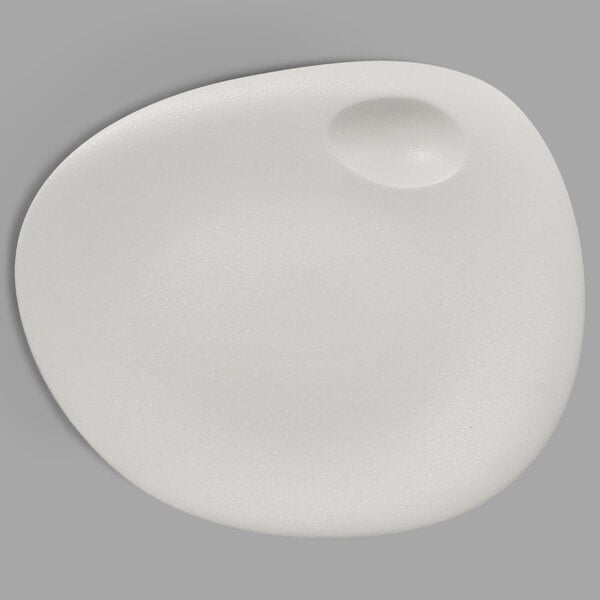 A white porcelain plate with a round hole in the middle.