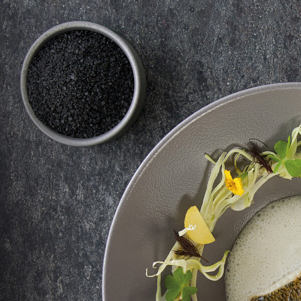 A plate of food with a stackable stone gray RAK Porcelain ramekin on it.