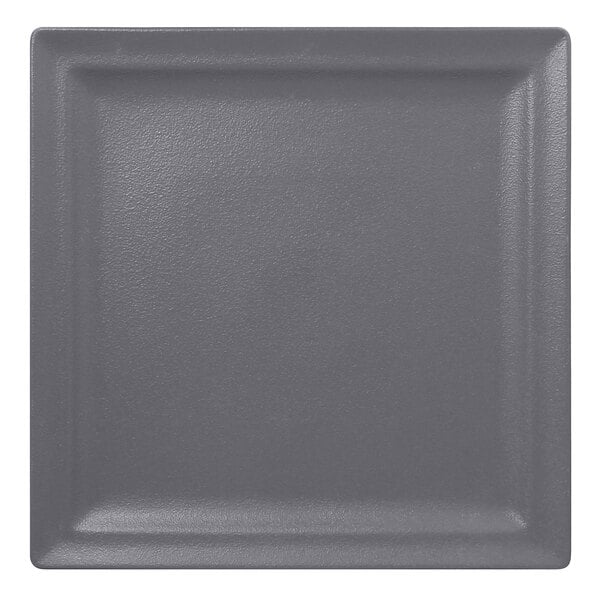 A RAK Porcelain square stone gray plate with a dark gray rim.