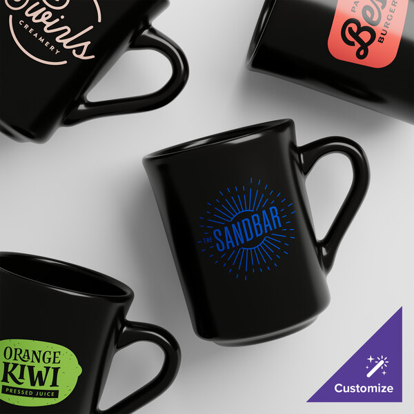 Four black Acopa Tiara stoneware mugs with different designs.