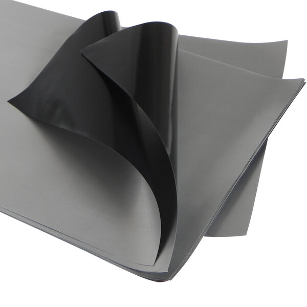 A stack of black PTFE release sheets with a white background.