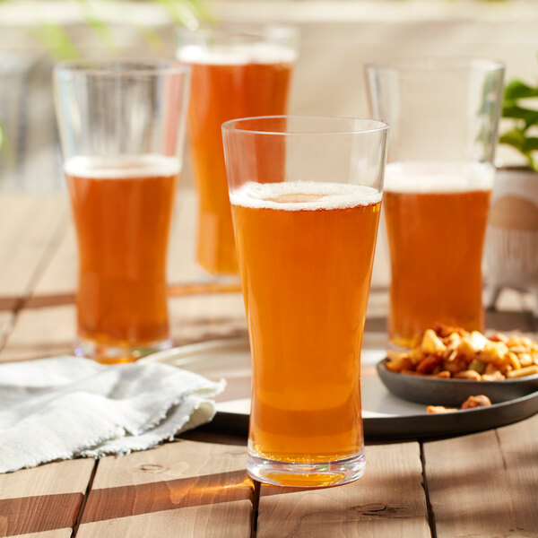 A group of Libbey Tritan plastic beer glasses on a table.