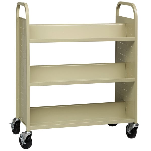 A tan metal Hirsh Industries book cart with black wheels.