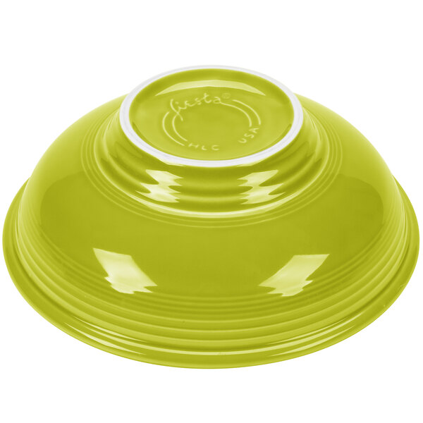 A lemongrass Fiesta pedestal serving bowl with a white rim.