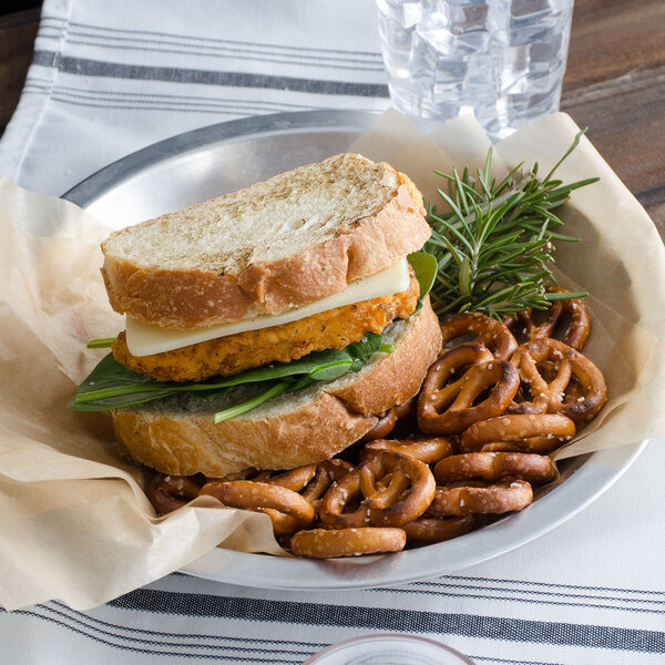 A sandwich with White Mild Cheddar cheese and spinach on a plate.