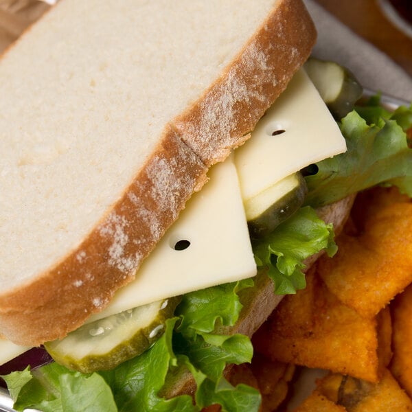 A sandwich with Great Lakes Swiss cheese and vegetables on a plate.