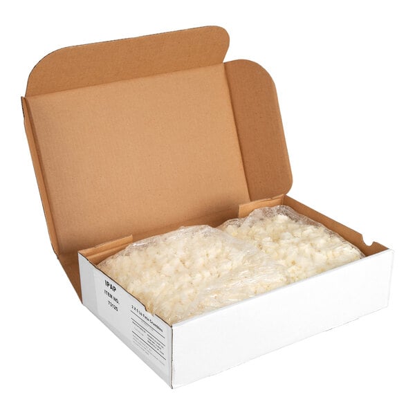 A white cardboard box containing two plastic bags of feta cheese crumbles.