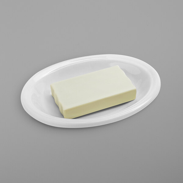 a white plate with a piece of butter on it