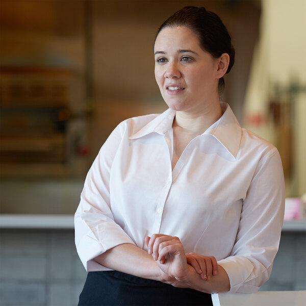 A woman in a Henry Segal white V-neck dress shirt.