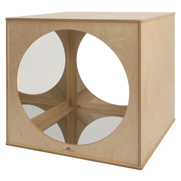 A Whitney Brothers wooden cube with a circular object in the middle.