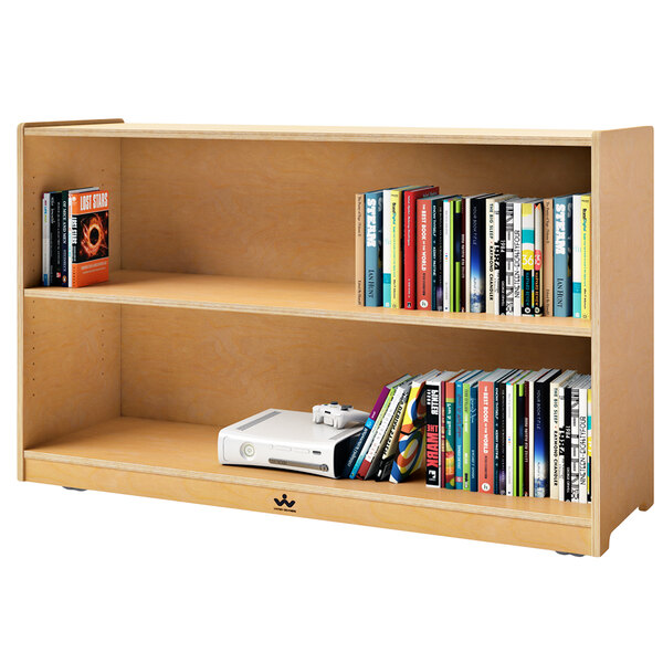 A Whitney Brothers mobile single shelf cabinet filled with books and a video game console.