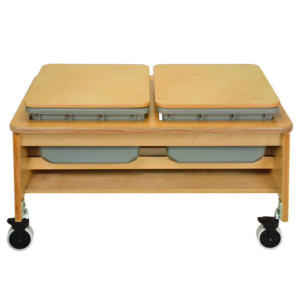 A wooden table with two storage bins on it.