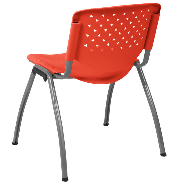 An orange plastic Flash Furniture stack chair with metal legs.