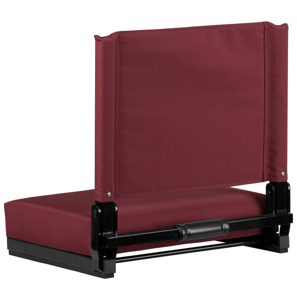 A Flash Furniture Grandstand stadium chair with a red seat and black frame.