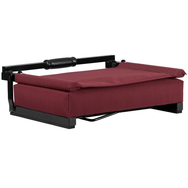 A maroon cushioned chair with a black frame.