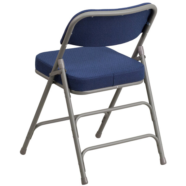 A navy blue Flash Furniture metal folding chair.