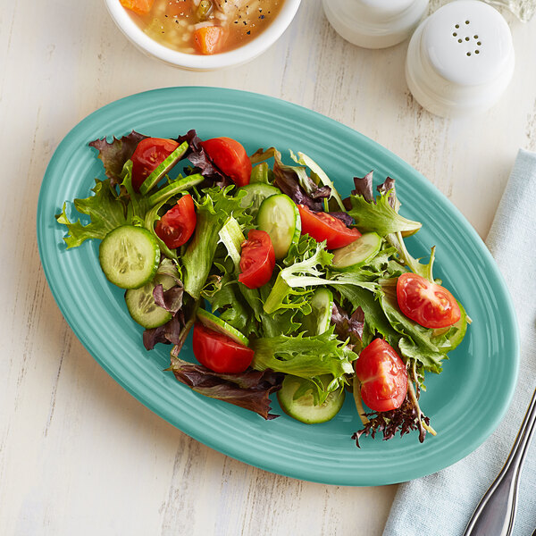 a plate of salad with tomatoes