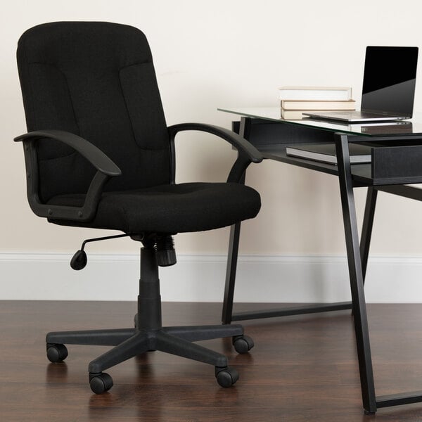 a chair and desk with a book on it