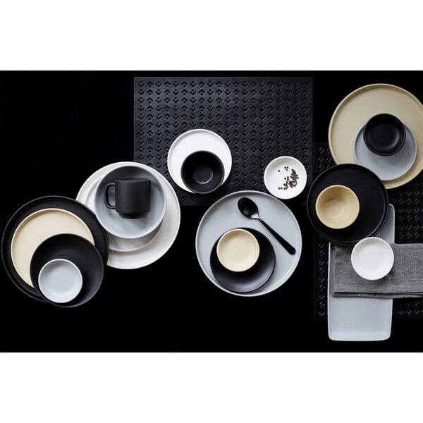 A white bowl with a black matte finish on a black surface.