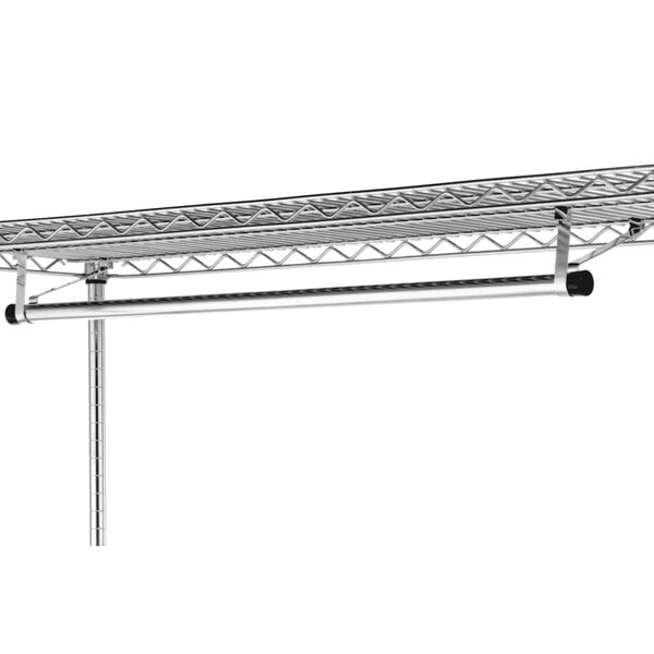 A metal rack with a long metal rod for hanging clothes.