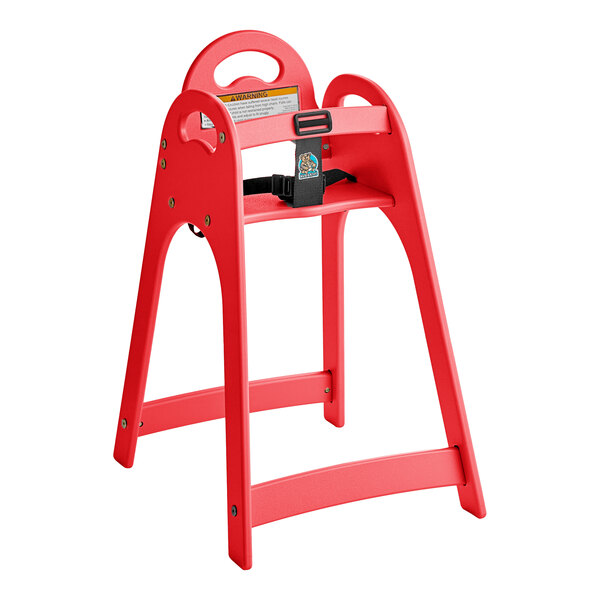 A red unassembled high chair with a safety strap and a handle cutout on the backrest.