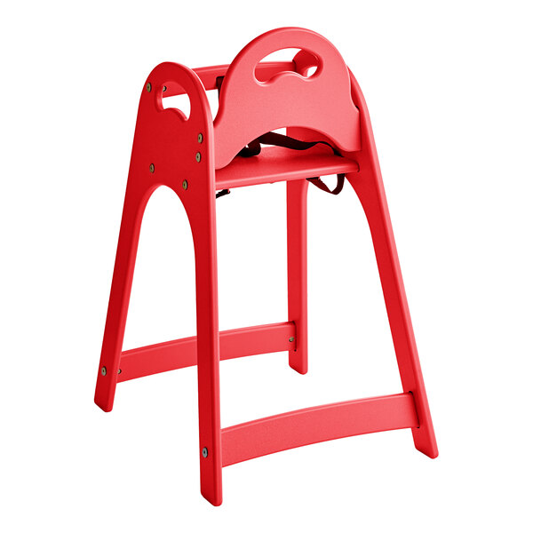 A red unassembled designer high chair with a simple, modern design and safety straps.