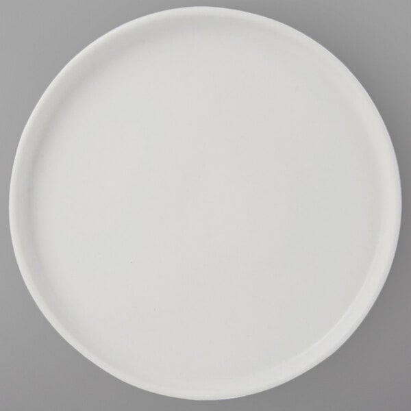 A Tuxton TuxTrendz white china plate with straight sides.