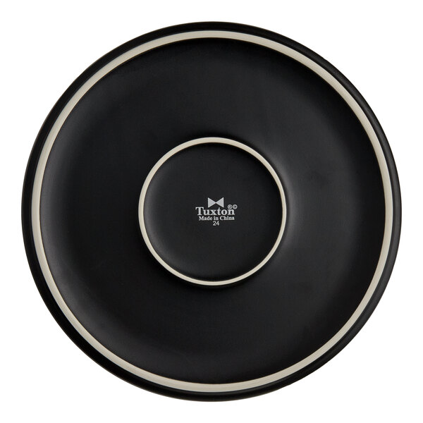 A black Tuxton china plate with a white rim.