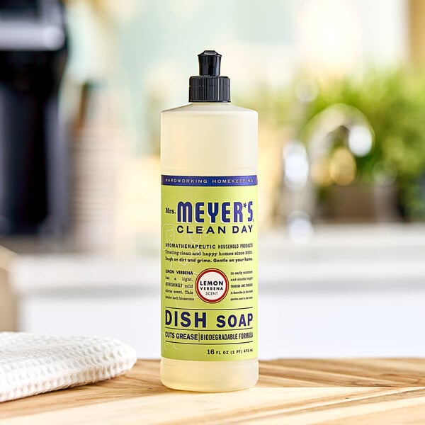 A bottle of Mrs. Meyer's Lemon Verbena scented dish soap on a kitchen counter.