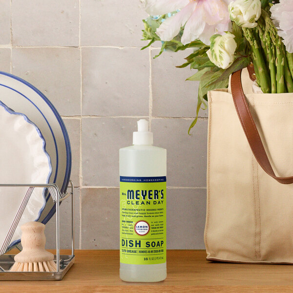 A bottle of Mrs. Meyer's Clean Day Lemon Verbena Scented Dish Soap placed on a kitchen counter.