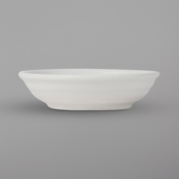 A white Tuxton China fruit bowl with an embossed design.