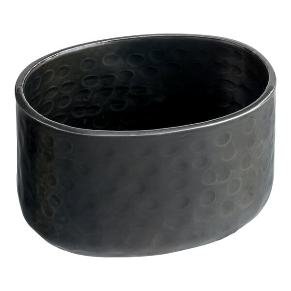 An American Metalcraft black oval bowl with a textured surface.
