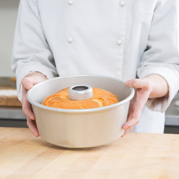 Baker holding an angel food cake pan