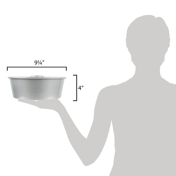 A woman holding a metal bowl with measurements.