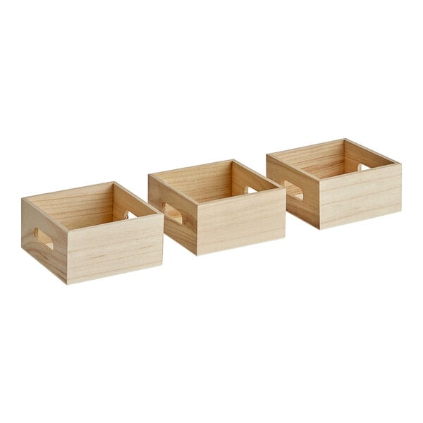 A group of Choice natural wooden display crates with handles.