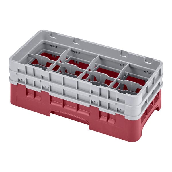 A red and gray plastic Cambro glass rack with compartments and extenders.