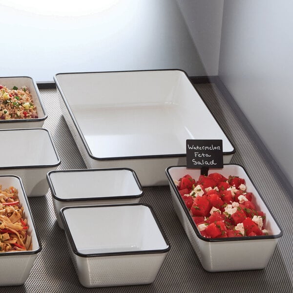 A white rectangular American Metalcraft melamine bowl with black trim filled with food.