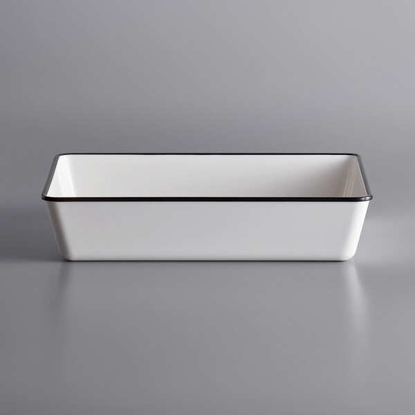 A white rectangular melamine serving bowl with black trim.
