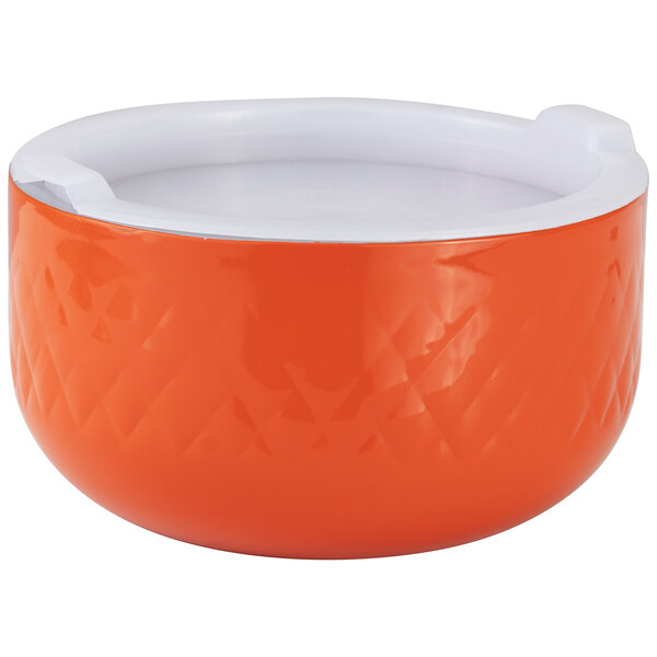 An orange bowl with a white interior and exterior.