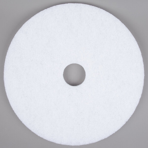 A white circular pad with a hole in the middle.