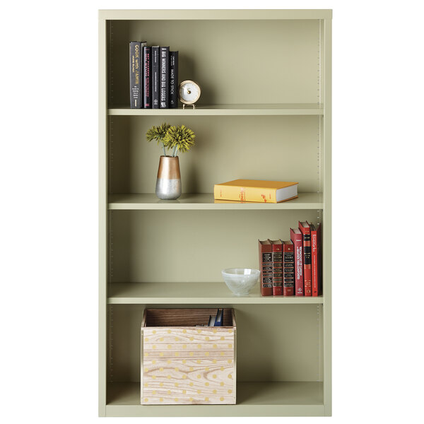 A Hirsh putty steel bookcase with books and a vase of flowers on top.