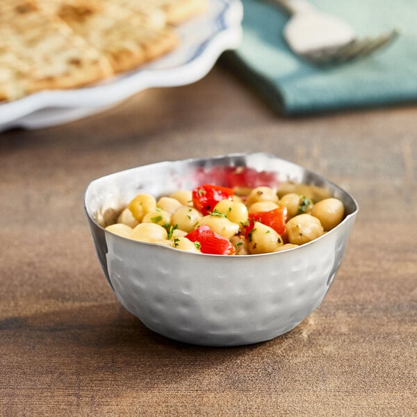 An American Metalcraft stainless steel snack bowl filled with food on a table.