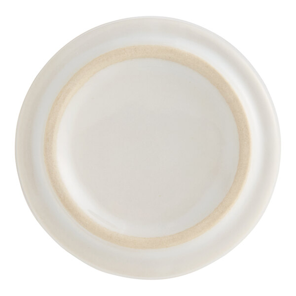 A white porcelain sauce cup with ribbed sides.