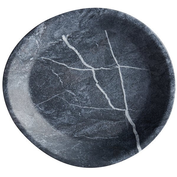 A black Carlisle soapstone melamine coupe plate with white lines.