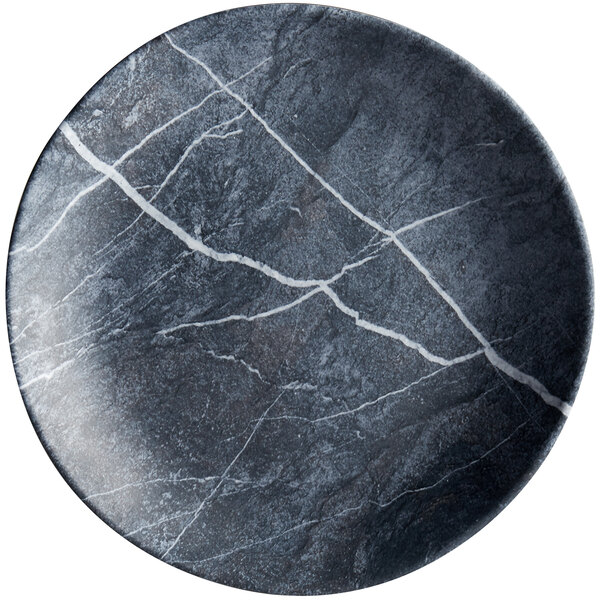 A black and white Carlisle soapstone melamine dinner plate with a crack.