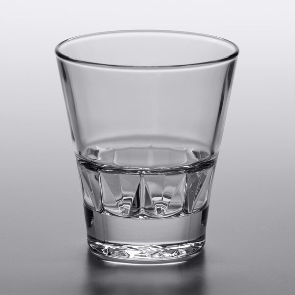 A Libbey stackable rocks glass with a clear liquid inside.