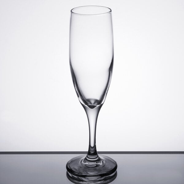 A Libbey clear wine flute with a small rim on top.