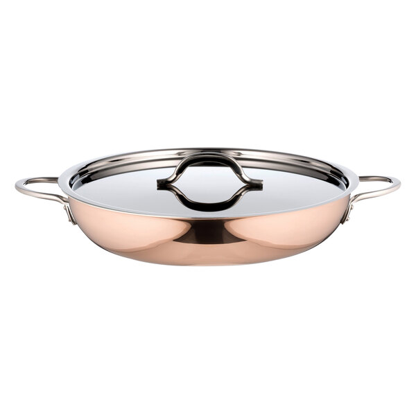 A copper saute pan with a lid and handle.