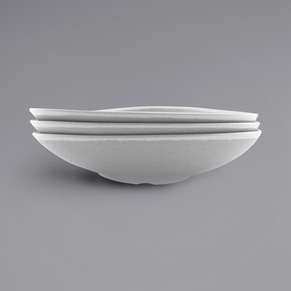 A close up of a gray speckled melamine triangle bowl.